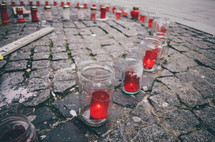 Memorial candles on paved a city street