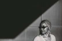 African-American woman wearing sunglasses and shadow