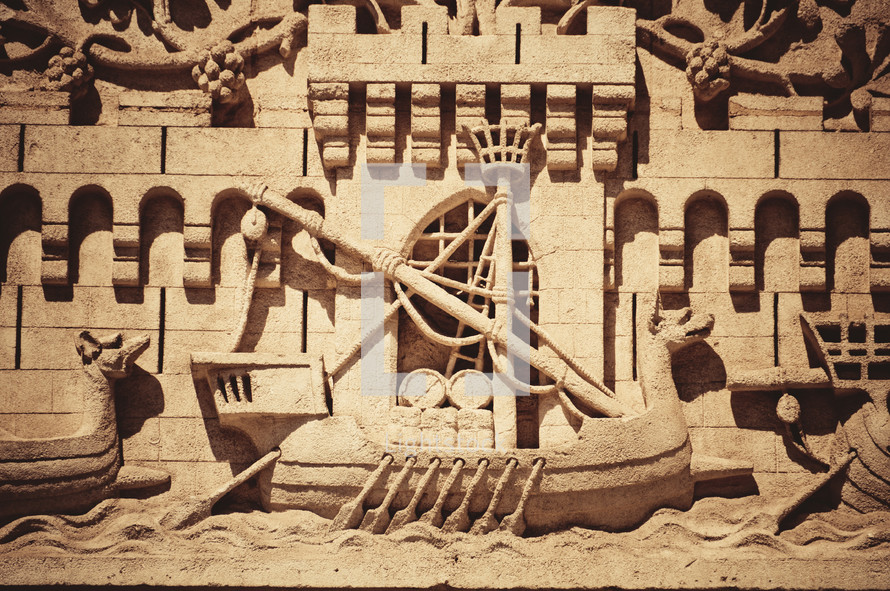 carving in stone of an ancient ship 