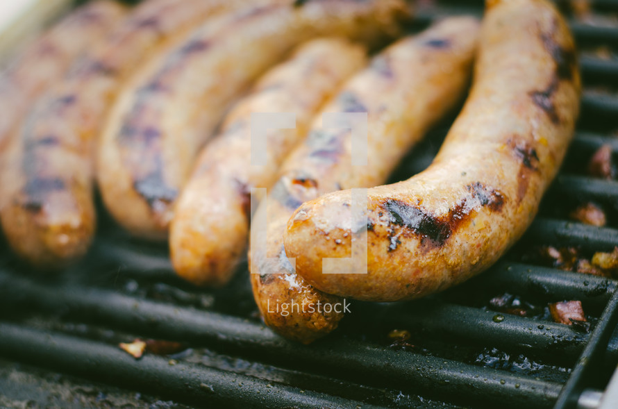 sausages cooking on a bbq grill