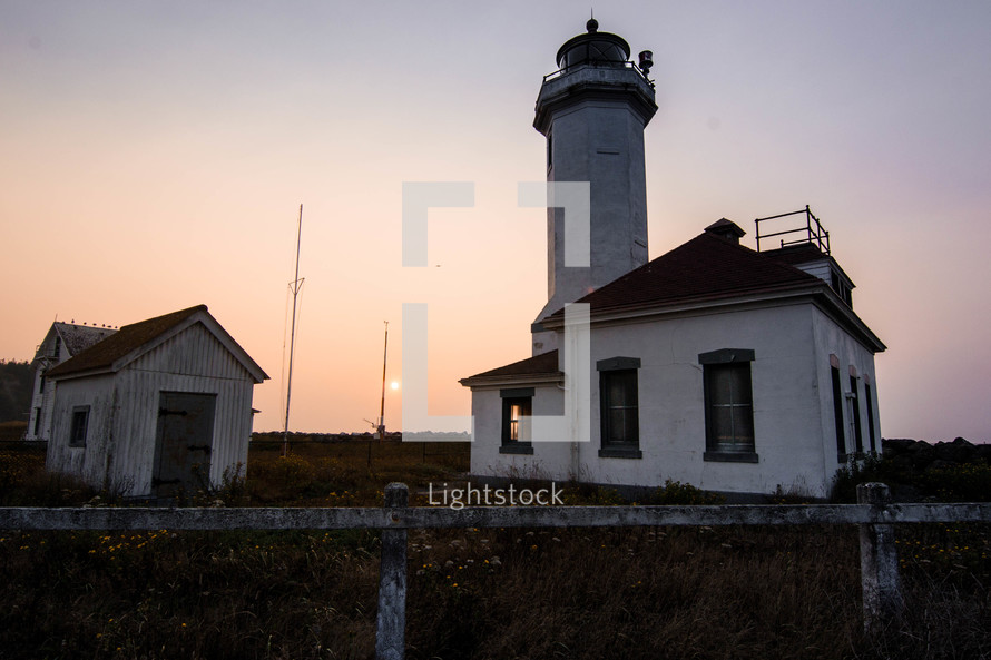 old lighthouse at sunset 