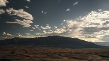 Dynamic view of mountains and clouds from a car window