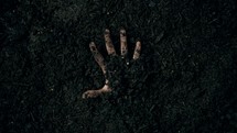 resurrection - hand reaching out of the ground 
