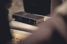 Bible sitting on a chair in a church worship service.