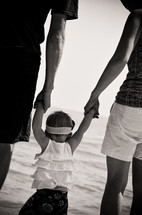 Family with baby girl on beach