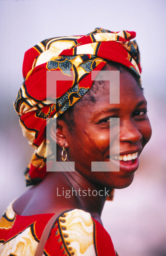 African woman in traditional clothing with face scarification or markings