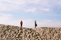 children standing on a sand dune 