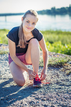 jogger tying her shoes 