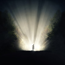 a shadow of a man standing in rays of light 