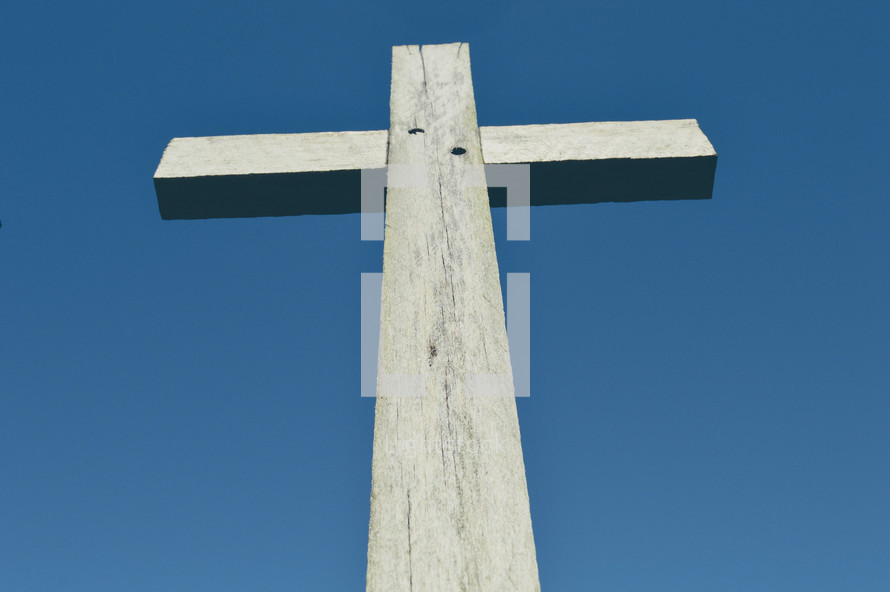 wooden cross against a blue sky 