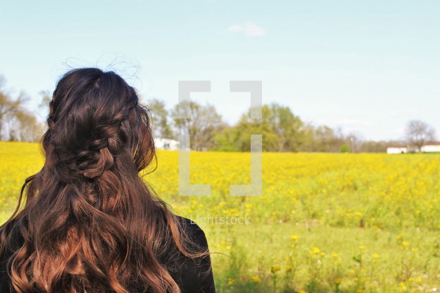 a woman looking into a meadow 
