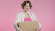 Excited smiling woman, online shopping consumer received cardboard order parcel box, desired purchase. Home courier delivery service. Sale, discounts. High quality 4k footage