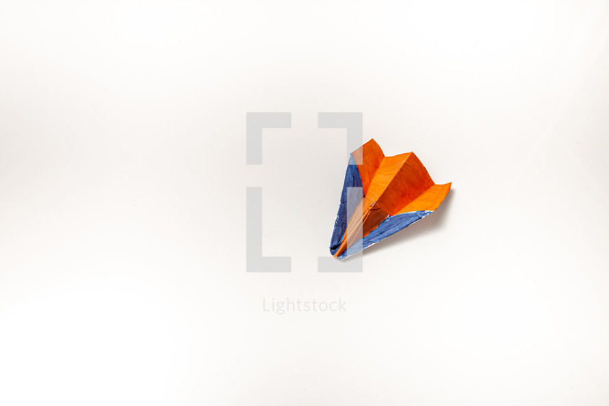 Color paper plane on a white background with copy space