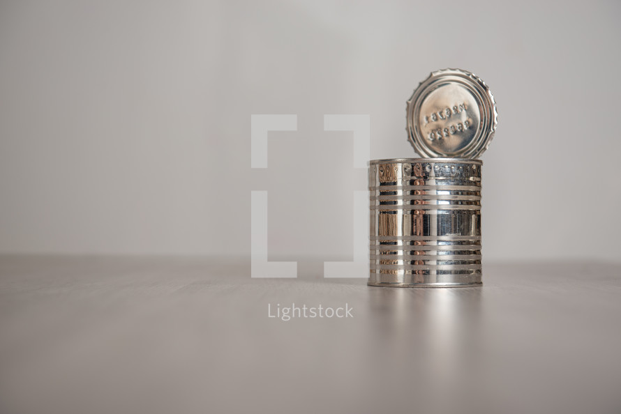 open tin can on a light background