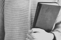 a woman holding a Bible 