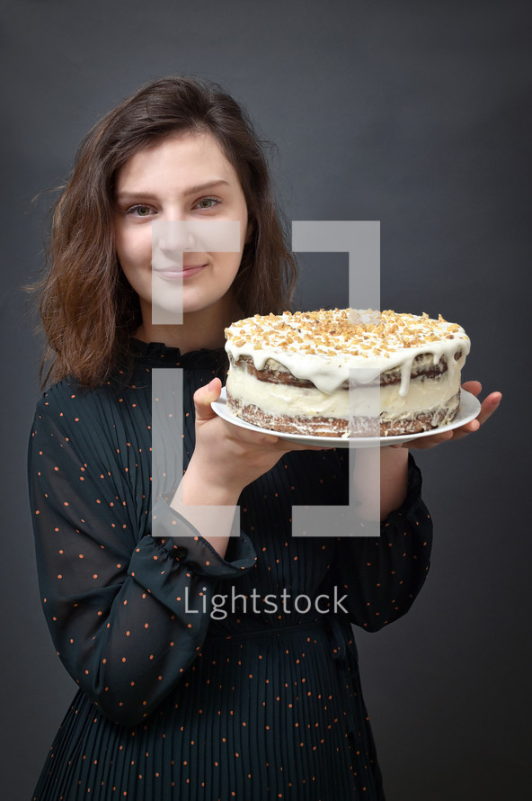 girl holding a cake 