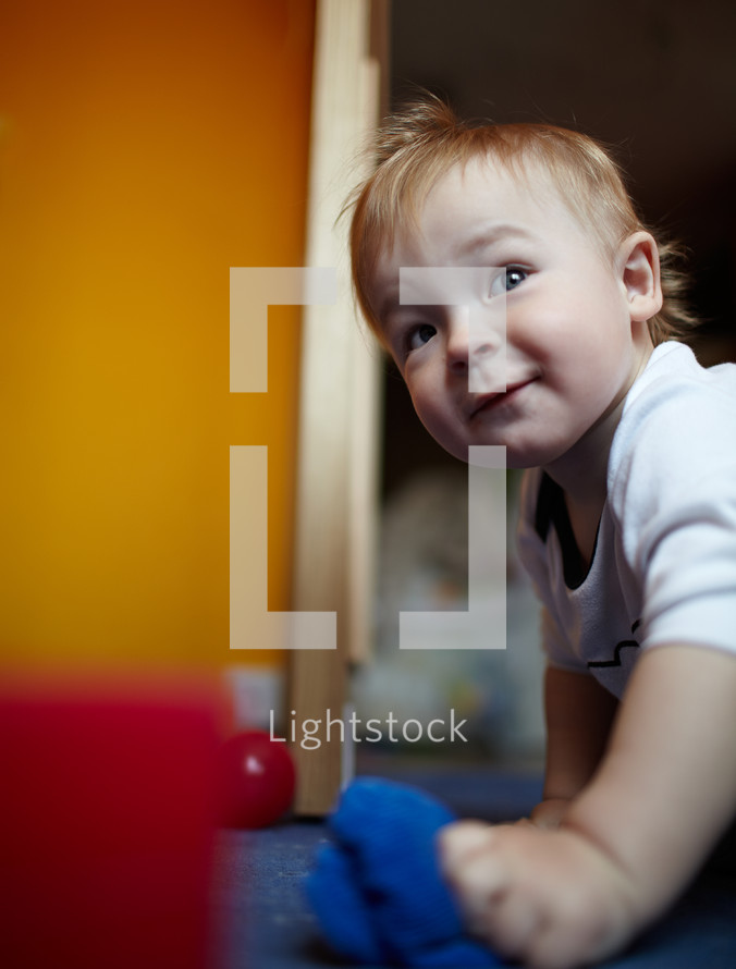 Little boy playing in his room
