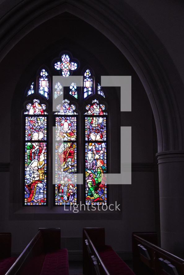 stained glass windows and church pews 