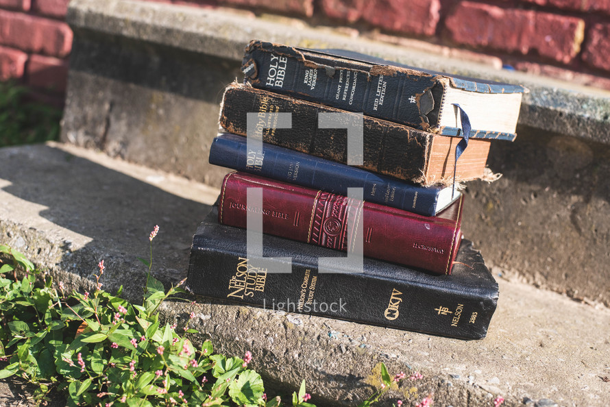 stack of old Bibles outdoors 