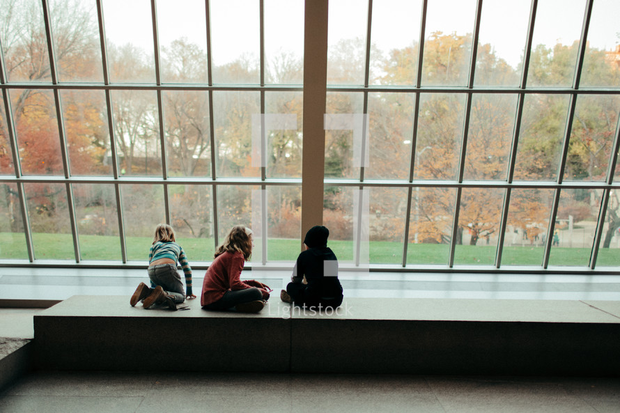 children looking out a window 
