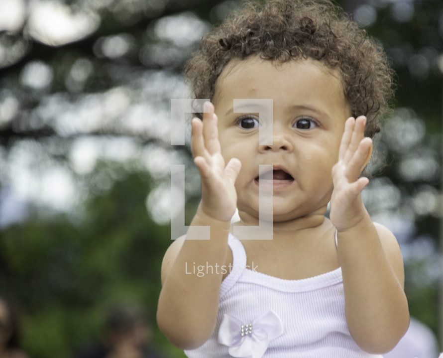 toddler girl with clapping hands 