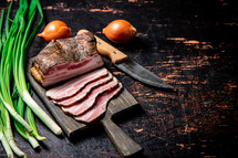 Pork lard cut on a cutting board. Against a dark background. High quality photo