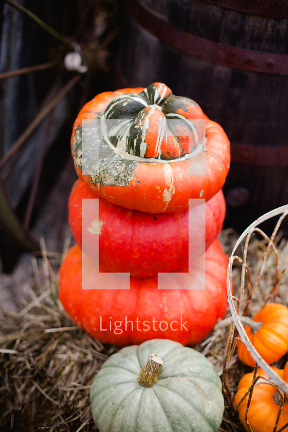 wagon wheel and stacked pumpkins 