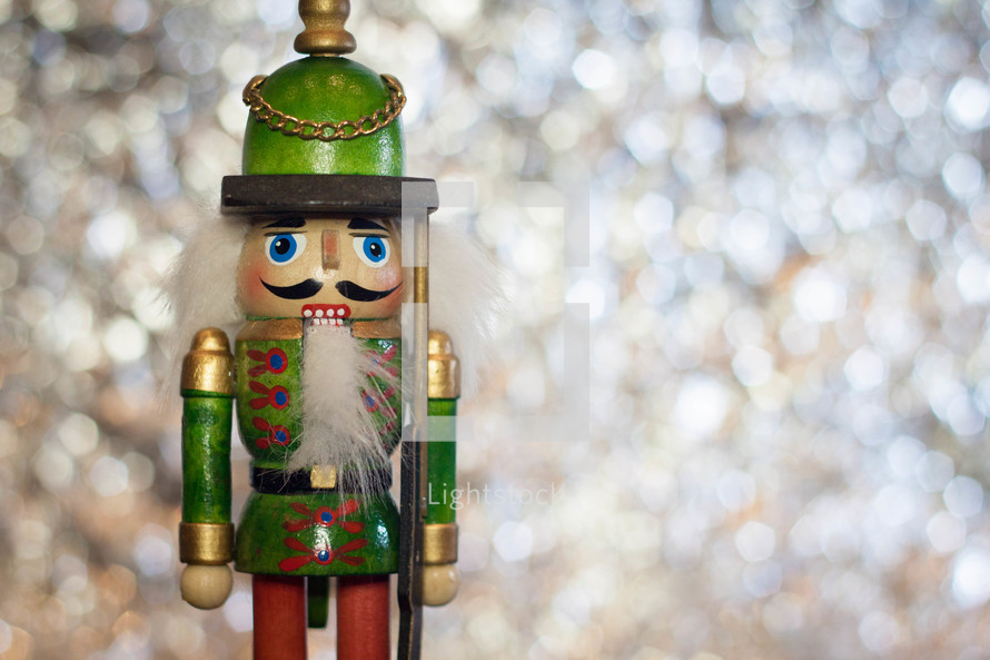 Traditional Wooden Soldier Christmas Nutcracker on a Sparkling Bokeh Background