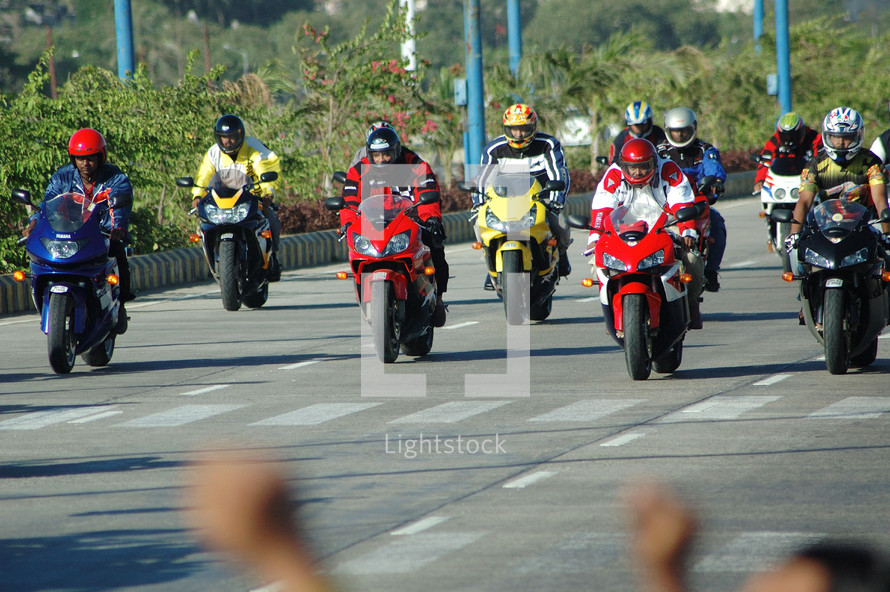 group of motorcyclists on a road 