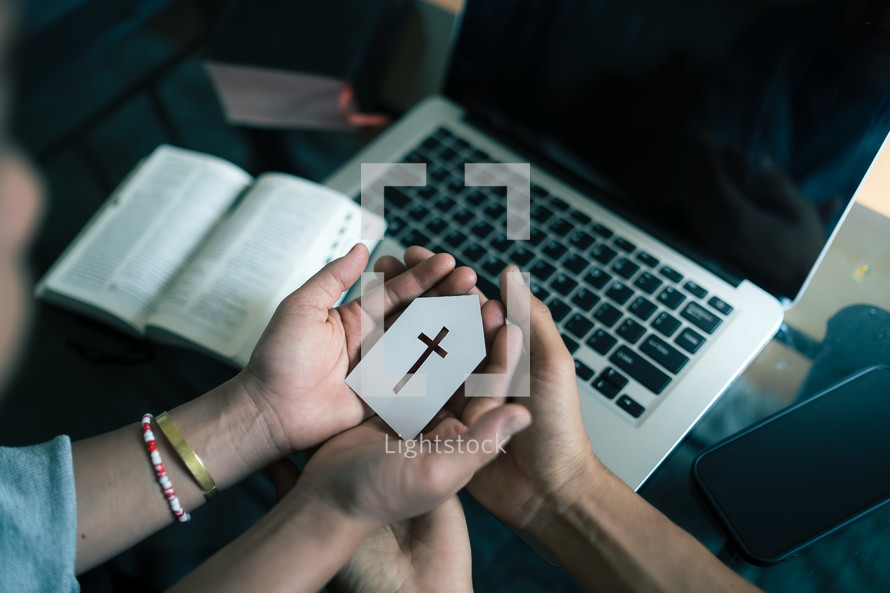 Man and woman holding paper church icon praying with computer laptop, Church services online concept, Online church at home, family christian concept.