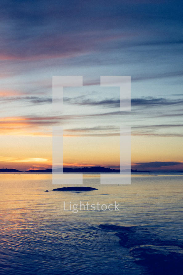 small rock island at sunset 