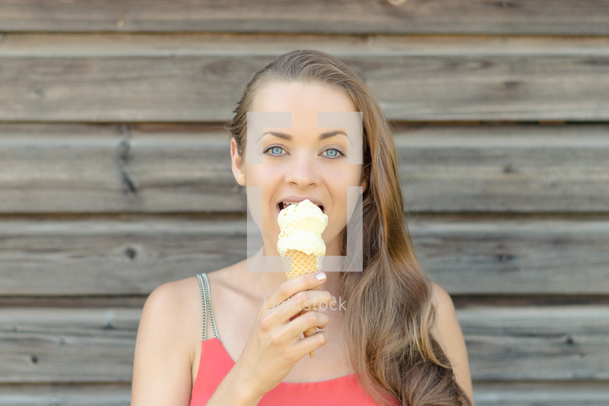 a woman eating an ice cream cone 
