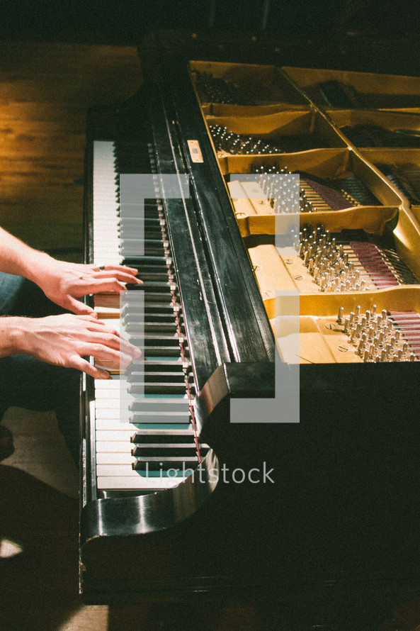 person playing a grand piano