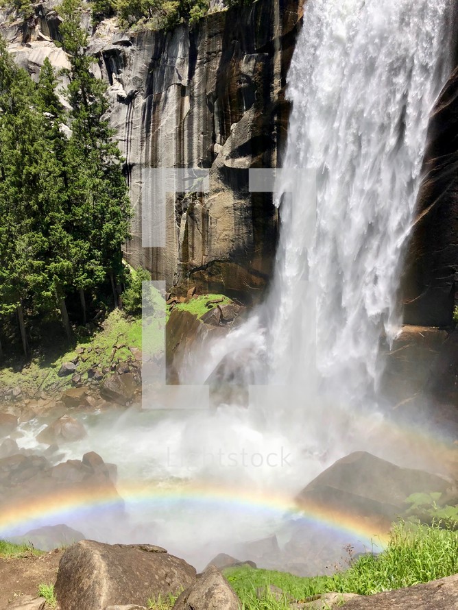 rainbow at the bottom of a waterfall 