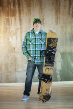 young man standing with a snow board 