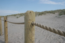 a rope fence on a beach 