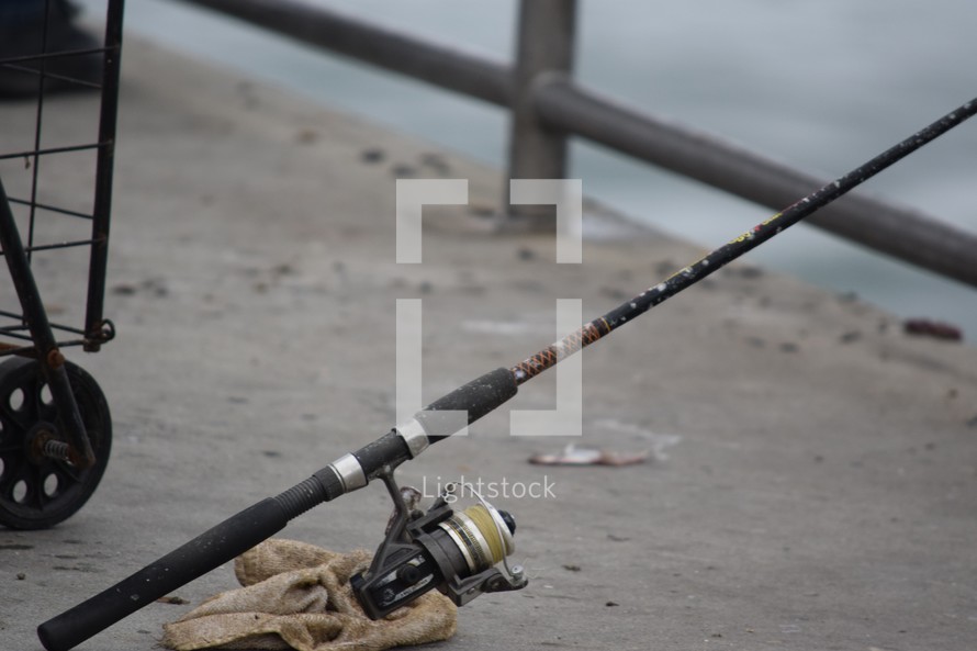 fishing pole on a pier 