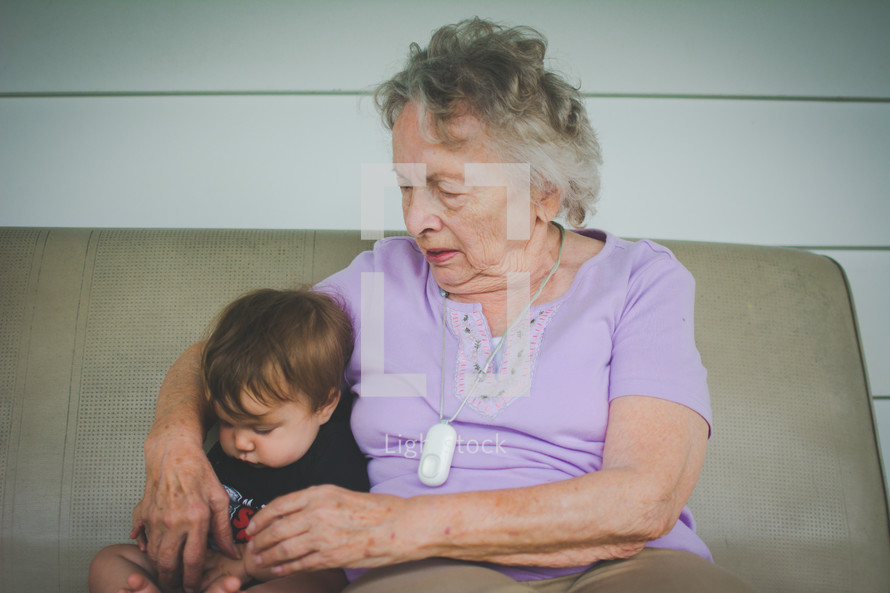 grandmother sitting with her infant grandson 
