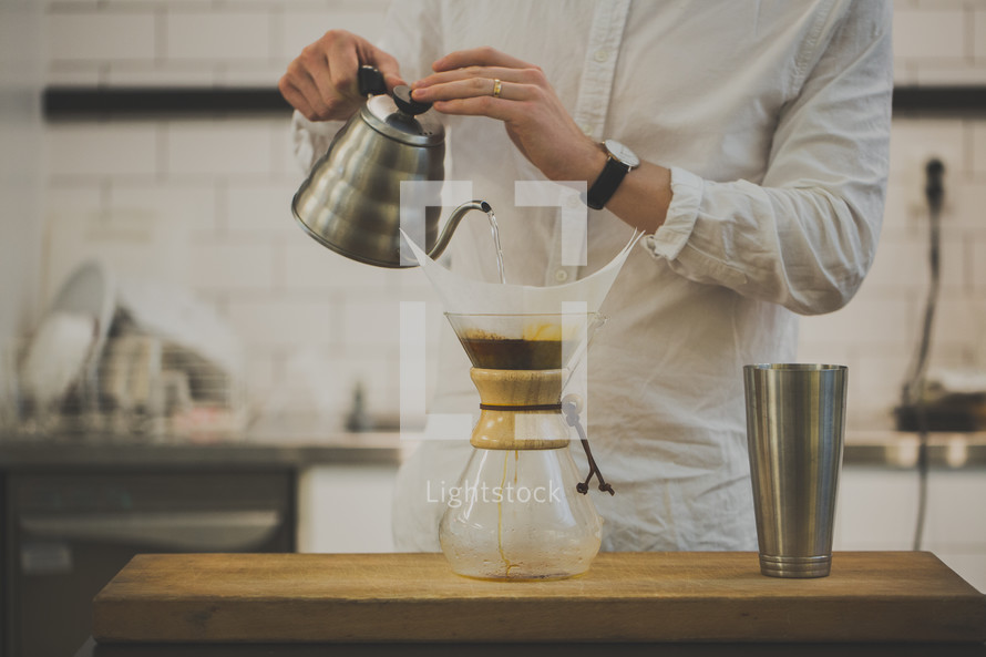 man using Chemex pour over coffee filter