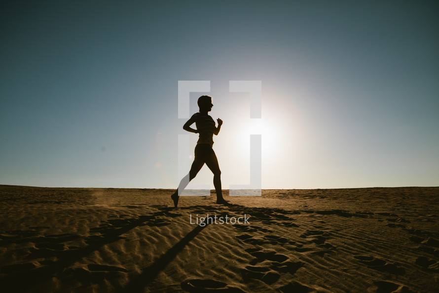 woman jogging in the sand 