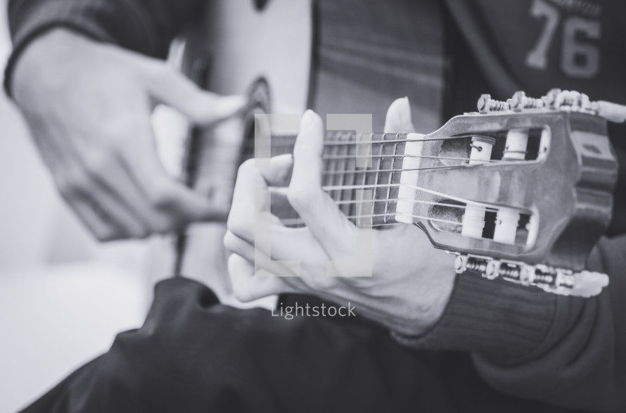 fingers on the neck of a guitar 