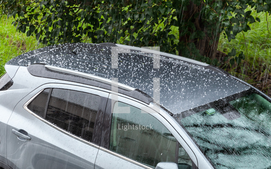 Hail falling on the roof of a car.