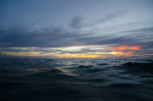 waves ripple across the ocean at dawn