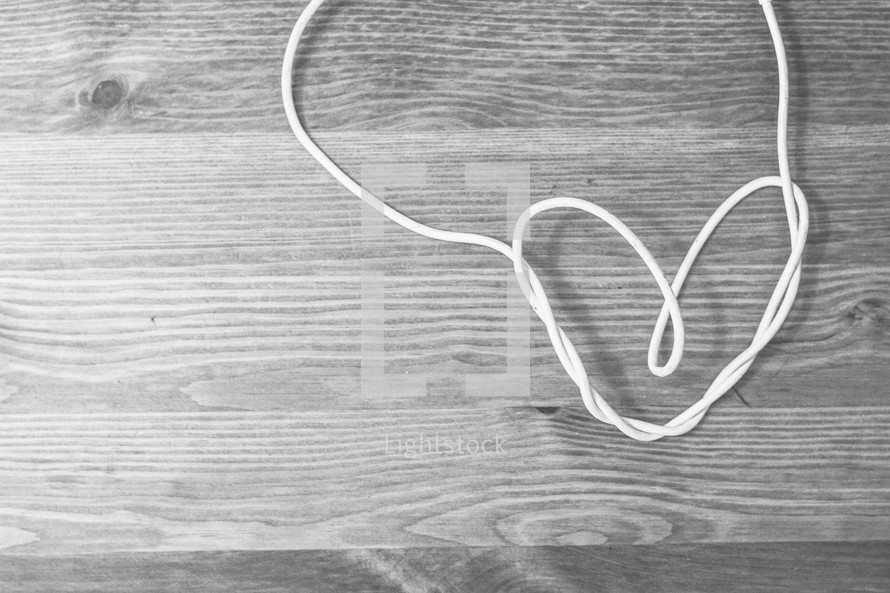 white cord forming a heart 