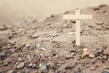 a wooden cross in the sand 
