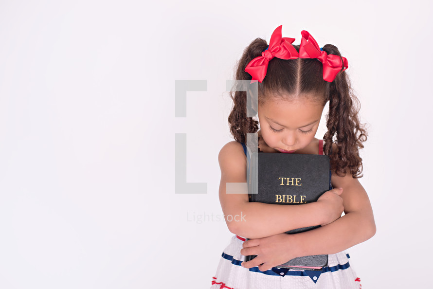 girl child holding a Bible 