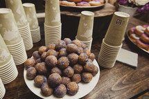 Plate of donut holes with cups