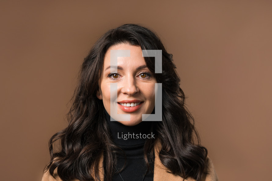 Stylish Brunette Woman Portrait, Close-Up. Natural Beauty. Mature Lady On Beige.