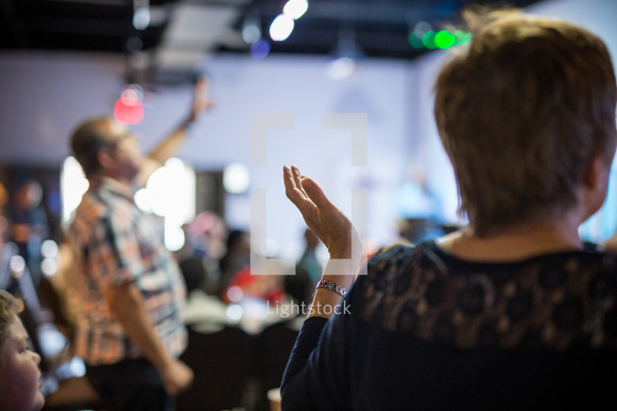 raised hands praising God at a conference 