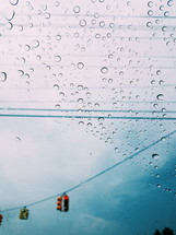 rain on a car window and stoplights 